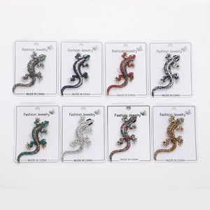 Detailed grid of eight rhinestone gecko brooches in various colors on white display cards
