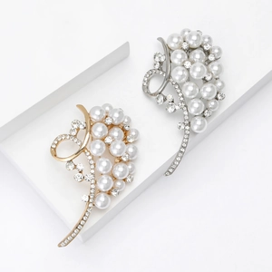 Elegant gold and silver leaf brooches with white pearls and sparkling rhinestones