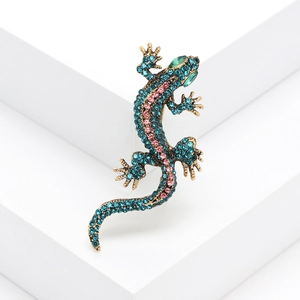 Exaggerated vintage lizard brooch with blue and pink rhinestones on a gold metal base