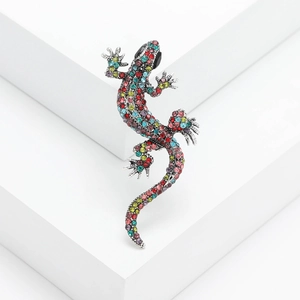 Detailed macro view of an ornate gecko brooch with vibrant multi-colored crystal rhinestones