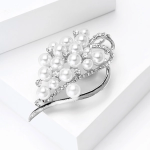 Detail of silver leaf brooch with clustered white pearls and crystal rhinestone inlay