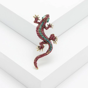 Sparkling gecko lizard brooch with red and teal rhinestones in a vintage gold finish