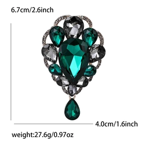 Detail view of emerald green vintage brooch showing dimensions 6.7cm by 4.0cm