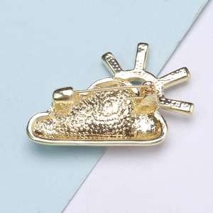 Detail view of the golden alloy brooch back showing a secure metal pin clasp mechanism