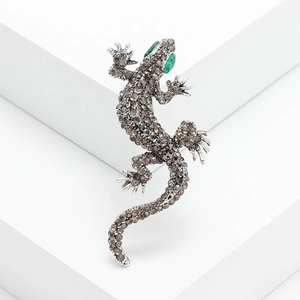 Exaggerated silver gecko brooch with grey rhinestones and green crystal eyes