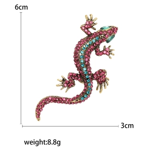 Sparkling crystal gecko brooch in gold alloy finish with pink and blue rhinestones