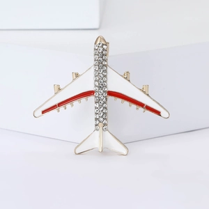 Creative gold-plated airplane brooch with white enamel wings and sparkling rhinestones