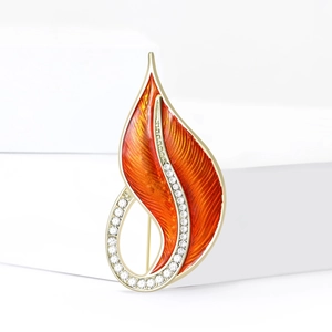 Elegant leaf-shaped enamel brooch with orange glaze and sparkling crystal accents