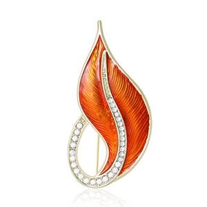Elegant leaf-shaped brooch with orange enamel and sparkling crystals on gold metal