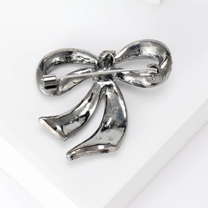 Vintage black pearl bow brooch in silver-tone alloy featuring a secure pin clasp closure
