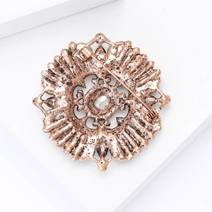 Detailed back view of vintage baroque brooch with embossed texture and metal pin fastener