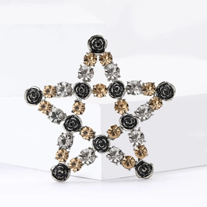 Elegant star brooch pin with black roses and champagne crystals on a white stone base