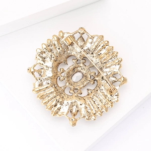 Detail view of the vintage gold alloy brooch back with pin clasp and center gemstone