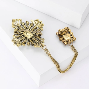 Detailed back view of vintage gold-tone chain brooch showing secure pin clasps and texture