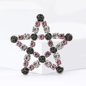 Star-shaped brooch featuring black roses and pink rhinestones on a silver base