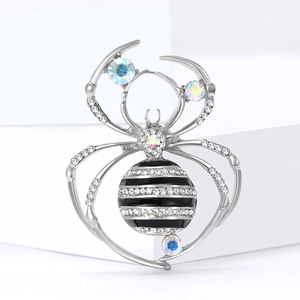 Silver spider brooch with sparkling rhinestones and black white striped enamel belly