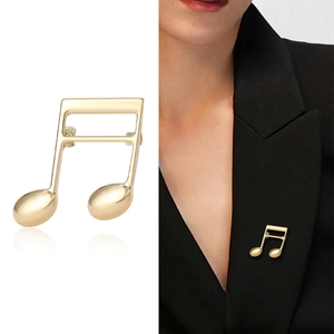 Elegant gold musical note brooch pin for suits with polished metallic finish for women