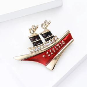 Detail of enamel steamship brooch with red and black accents and sparkling rhinestones