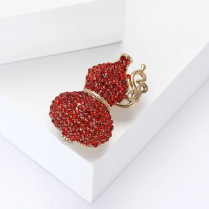 Luxury gold alloy gourd brooch with red rhinestones and elegant scrollwork on a white stand