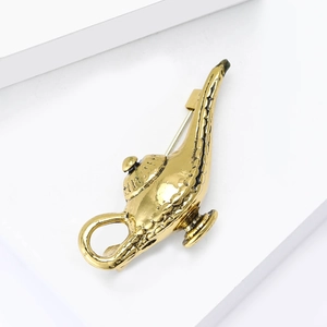 Detailed macro view of the alloy Aladdin lamp brooch with embossed golden plating