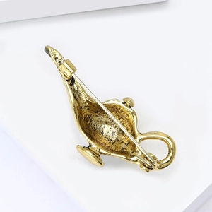 Detailed back view of Aladdin lamp brooch showing safety pin clasp and antique gold finish