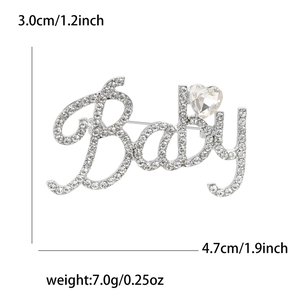 Vue détaillée de la broche Baby argentée avec strass scintillants et pierre en cœur
