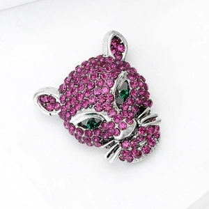 Macro detail of high-end leopard brooch with pink rhinestones and green crystal eyes