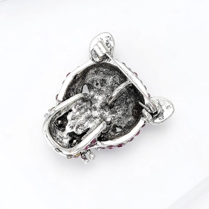 Silver leopard head brooch back view with metal pin clasp and red rhinestone details