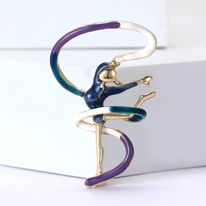 Detail of artistic gymnastics girl brooch with blue enamel inlay on golden alloy base