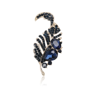 Vintage gold feather brooch with dark blue rhinestones and faceted crystal gems