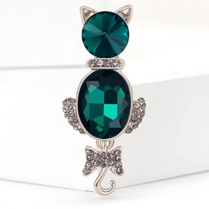 Elegant cat brooch featuring large emerald green crystals and sparkling rhinestone accents