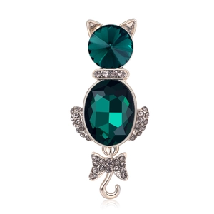 Elegant cat brooch featuring green faceted gemstones and sparkling rhinestones in gold finish