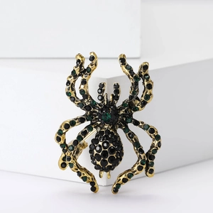 Vintage spider brooch pin with black and green rhinestones on gold alloy frame