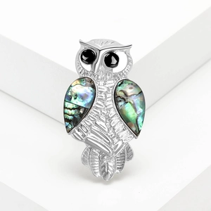 Elegant owl brooch with colorful abalone shell inlays on polished silver metal finish