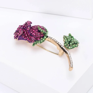 Macro di un'elegante spilla a rosa con strass viola e dettagli stelo in oro lucido