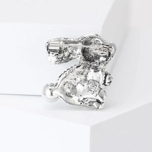 Back view of silver alloy rabbit brooch showing secure metal pin clasp and texture