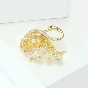 Exquisite swan brooch with gold finish and gradient yellow marquis zirconia stones