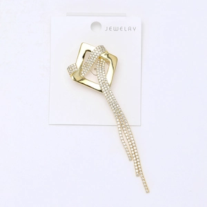 Macro detail of high-grade crystal square tassel brooch with pavé zircon stones