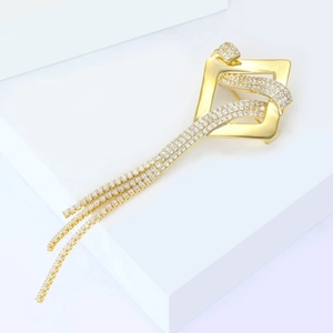 Macro shot of luxury gold geometric brooch featuring shimmering zircon tassels and inlay