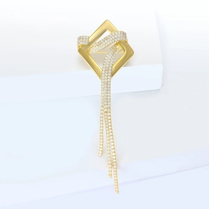 Elegant gold square tassel brooch with pavé zircon crystals on a minimalist white display