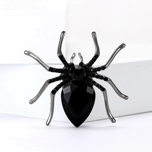 Close-up of gothic spider brooch with large black pear-cut crystal and rhinestones
