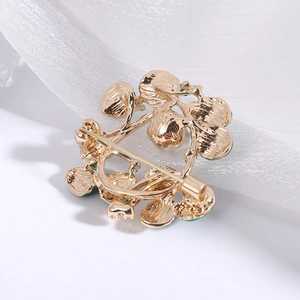 Detail view of the alloy floral brooch back with secure pin clasp and gold finish