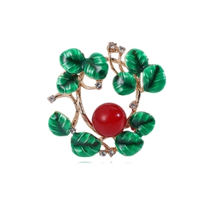 Floral wreath alloy brooch with green enamel leaves, red bead and white crystals