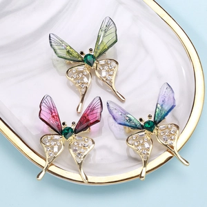 Macro view of butterfly brooches with resin wings and shimmering zircon insets