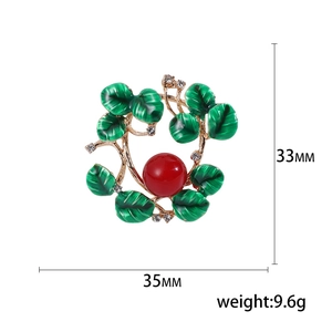 Floral wreath brooch with green enamel leaves, red bead, and crystals, 33x35mm size