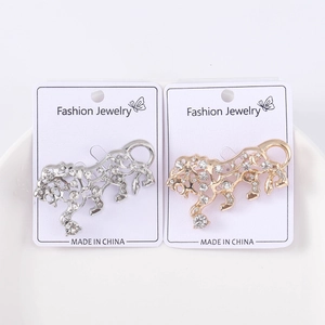 Detailed view of hollow tiger brooches in gold and silver finish with sparkling rhinestones