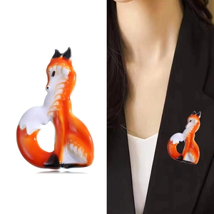 Cute enamel fox brooch pin for women, featuring orange and white gradients on a black blazer