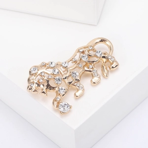 Macro view of gold-plated hollow tiger brooch with sparkling inlaid rhinestones