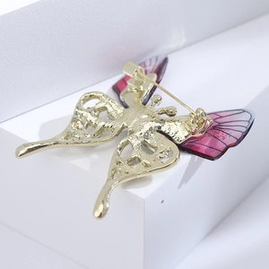 Detailed back view of gold butterfly brooch with a secure metal pin and hollow pattern