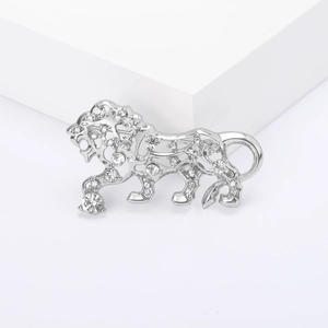 Elegant hollow silver tiger brooch with clear crystals on a white platform
